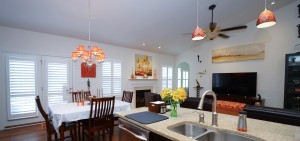 Indoor kitchen and living room view of custom window shutters
