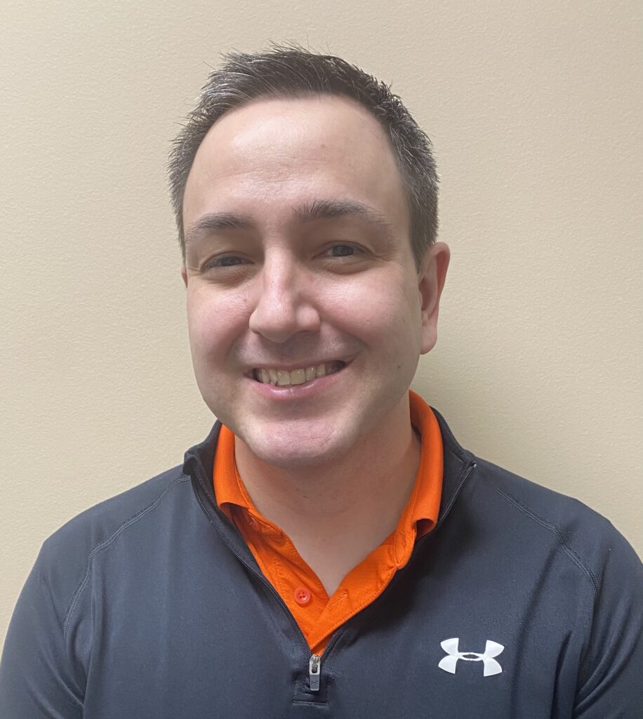 a man wearing an orange and black shirt