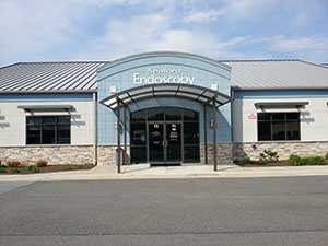 the front entrance of a building with a blue sky in the background