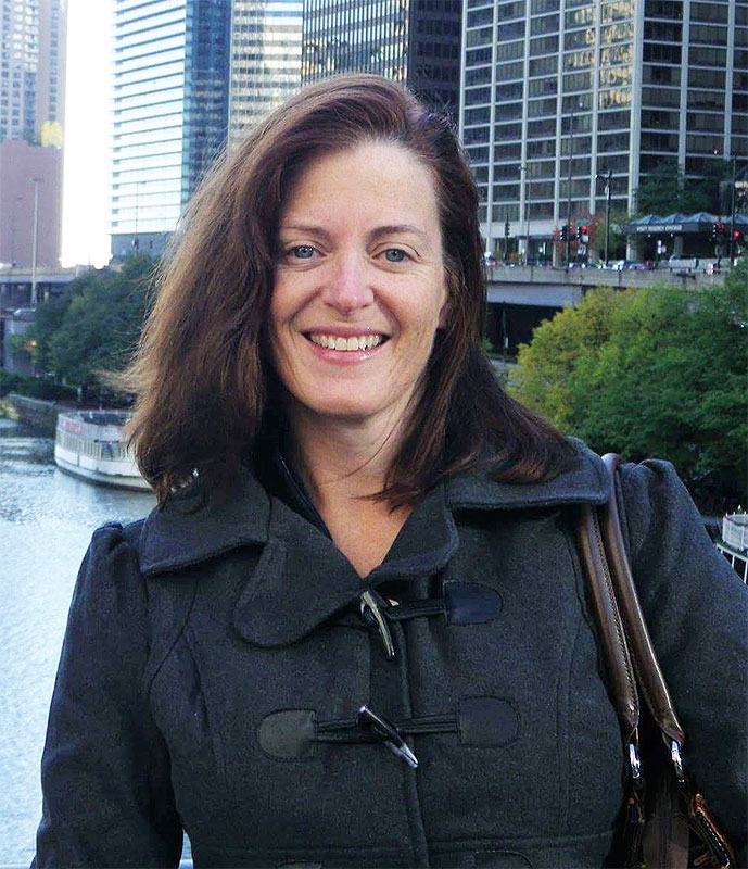 a woman standing in front of a body of water