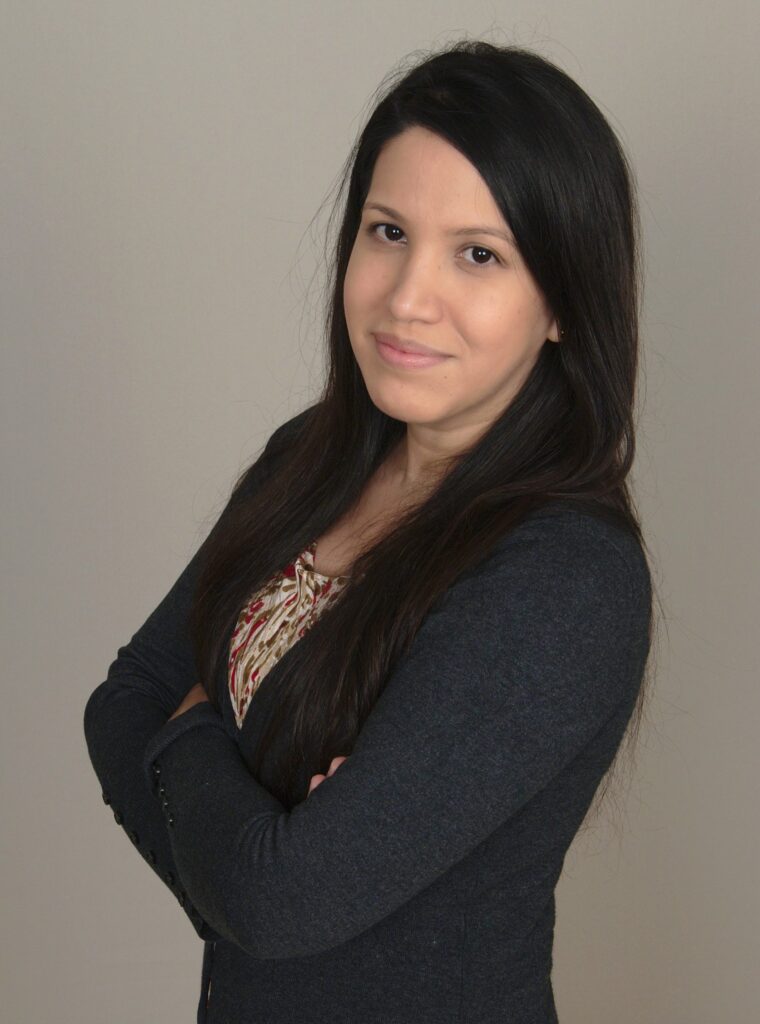 a woman with long black hair is posing for the camera