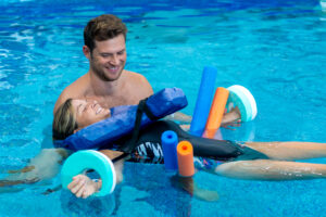 a man and a little girl are in the pool