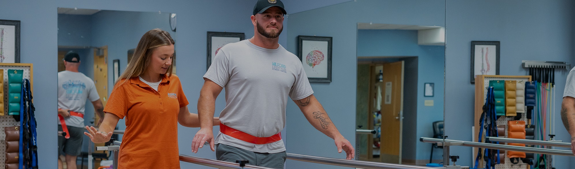 a man and woman walking down a hospital hallway