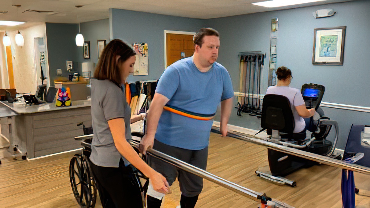 a man in a wheel chair and a woman standing next to him