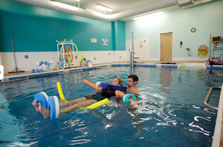 a man and a child in a swimming pool