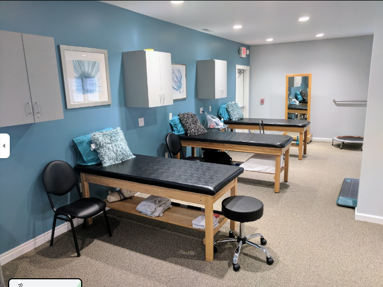 a room with several tables and chairs in it