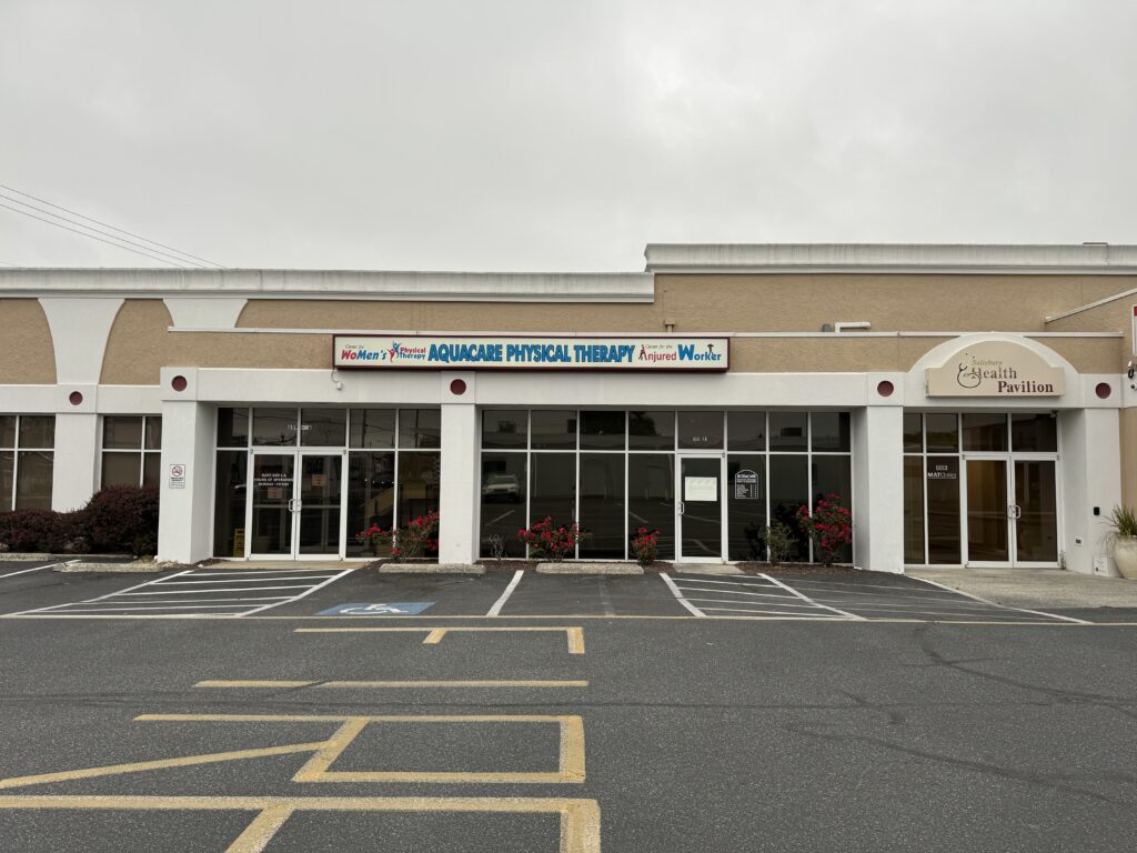 the front of a building with a parking lot in front of it