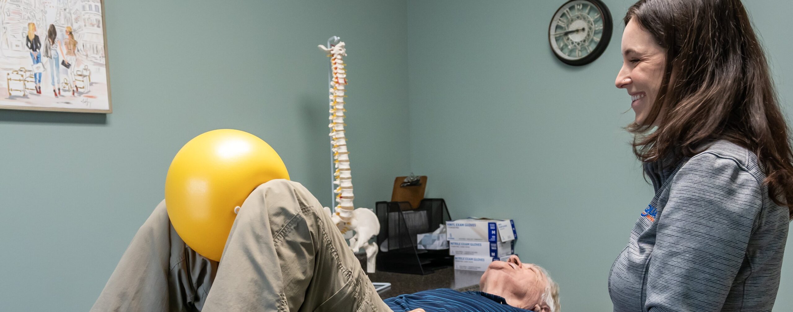 Physical Therapy for Bowel Dysfunction a man laying on a table with a yellow balloon on his head