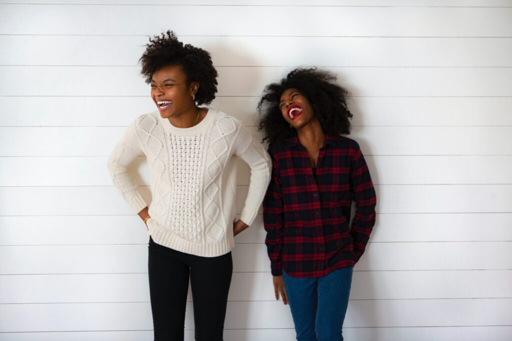 two women standing next to each other smiling