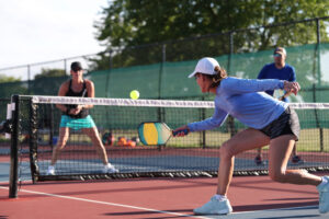 a woman is playing tennis on a court