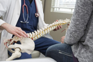 a doctor examining a human skeleton in a room
