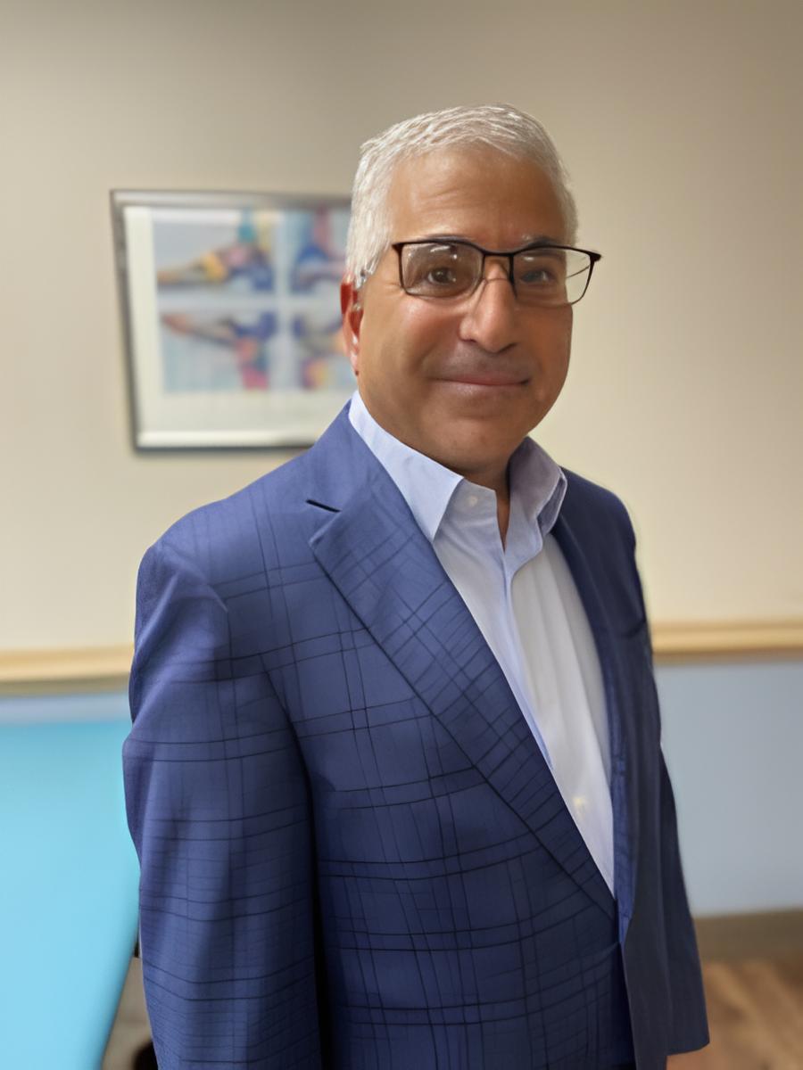 a man in a blue suit and glasses