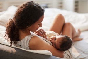 a woman holding a baby on her lap