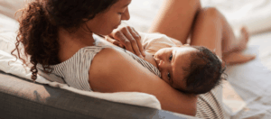 a woman holding a baby on her lap