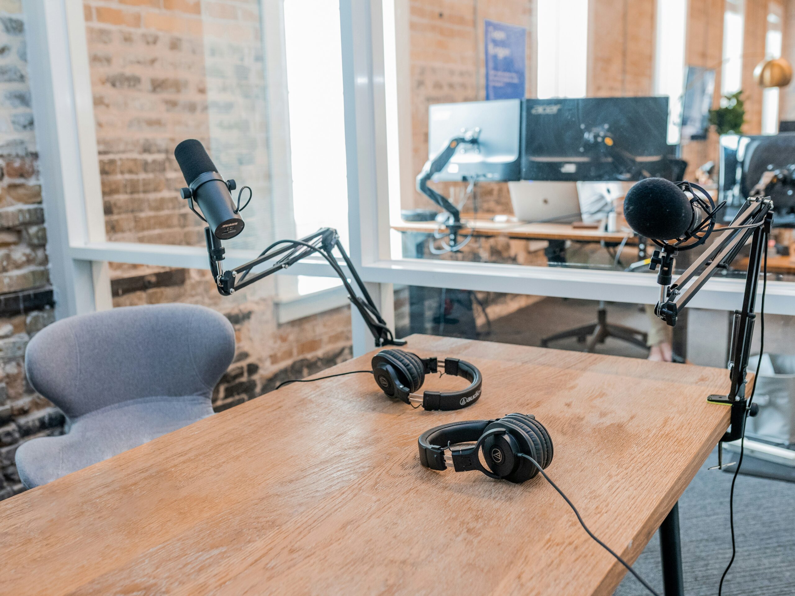a desk with headphones on it in an office