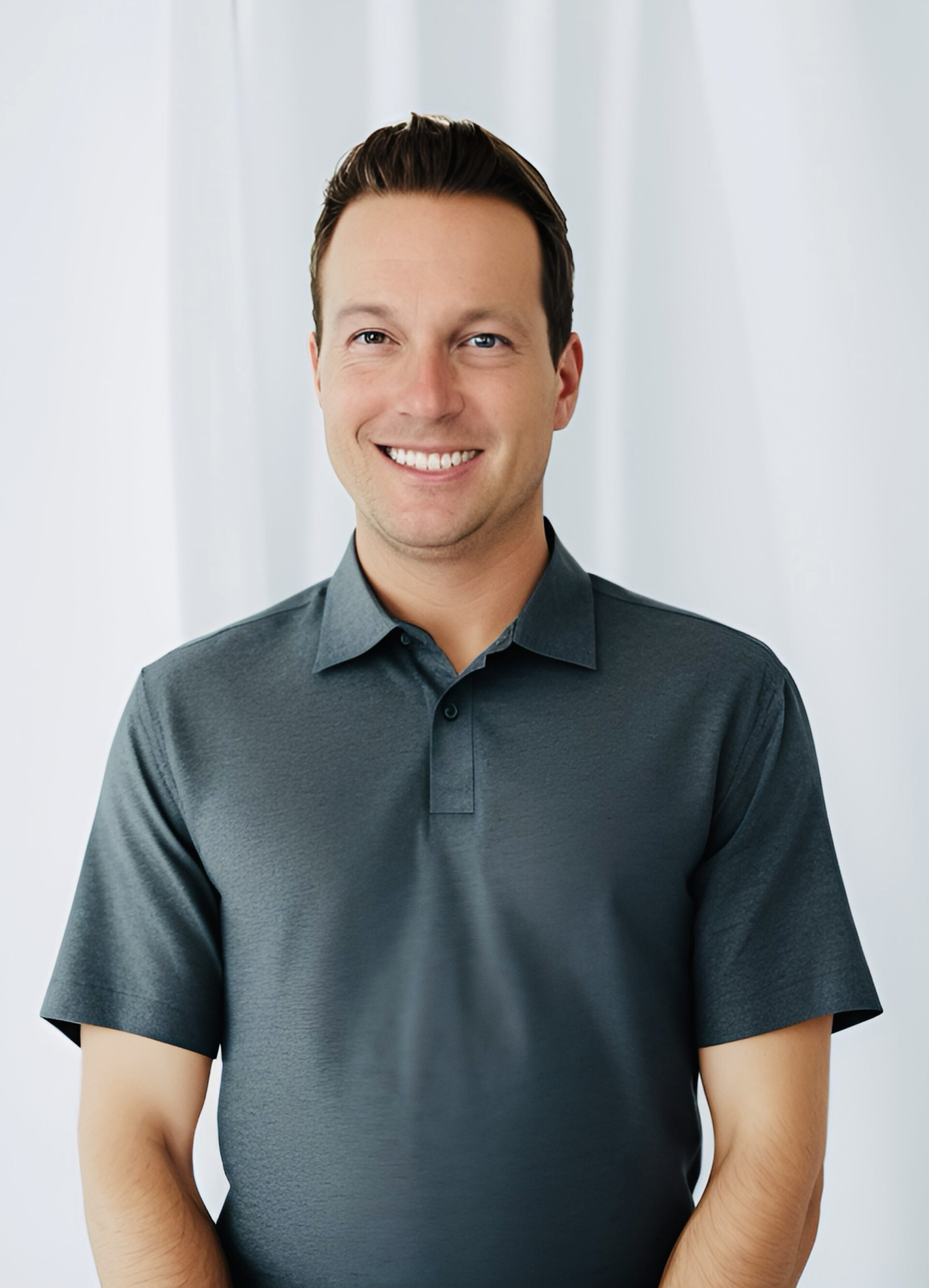 a man standing in front of a white curtain