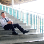 a man sitting on a set of stairs