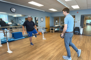 a couple of men standing on top of a hard wood floor