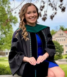 Hannah Barger wearing graduation gown and blue dress