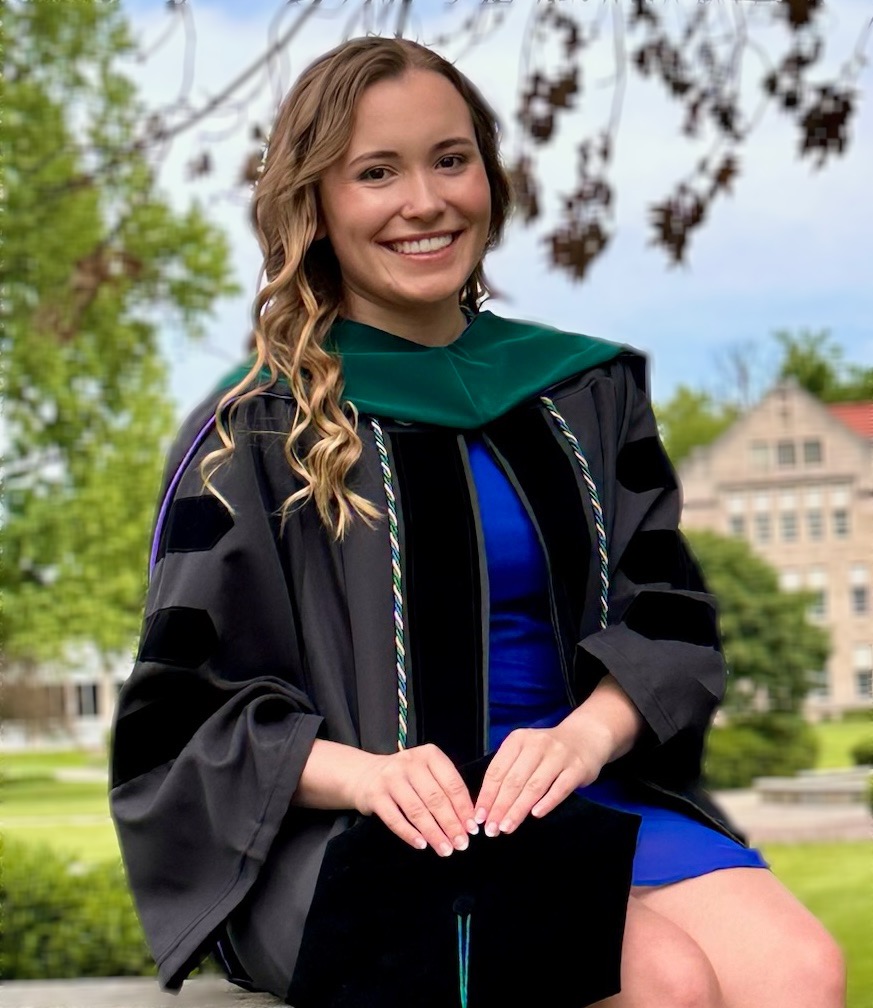 Hannah Barger wearing graduation gown and blue dress