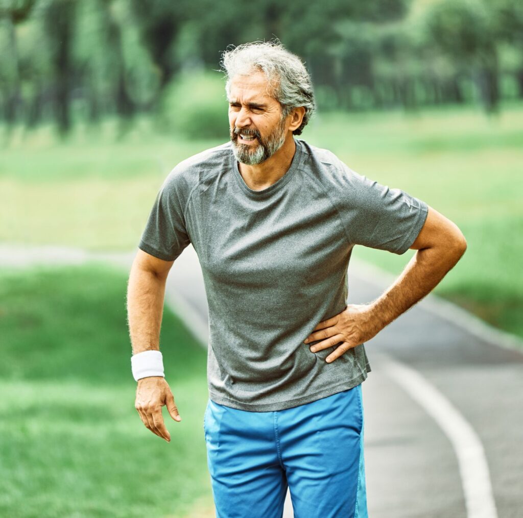 a man standing on the side of a road with his hands on his hips