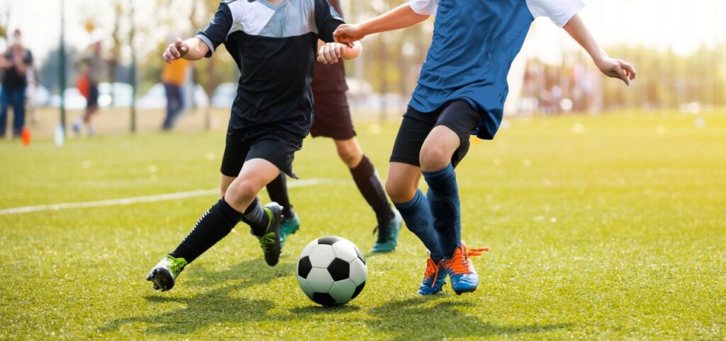 a group of young men kicking around a soccer ball