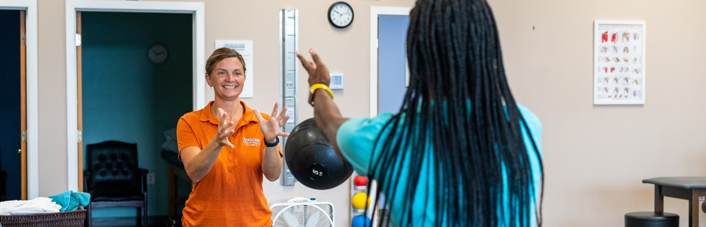 a woman in an orange shirt standing in a room