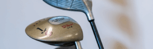 a close up of two golf clubs and a driver