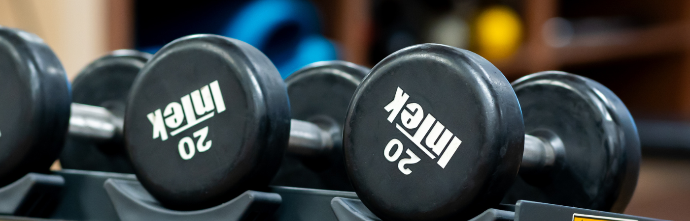 a row of black dumbbells sitting on top of each other