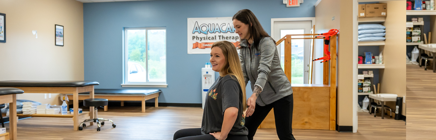 a woman standing next to a young girl in a room