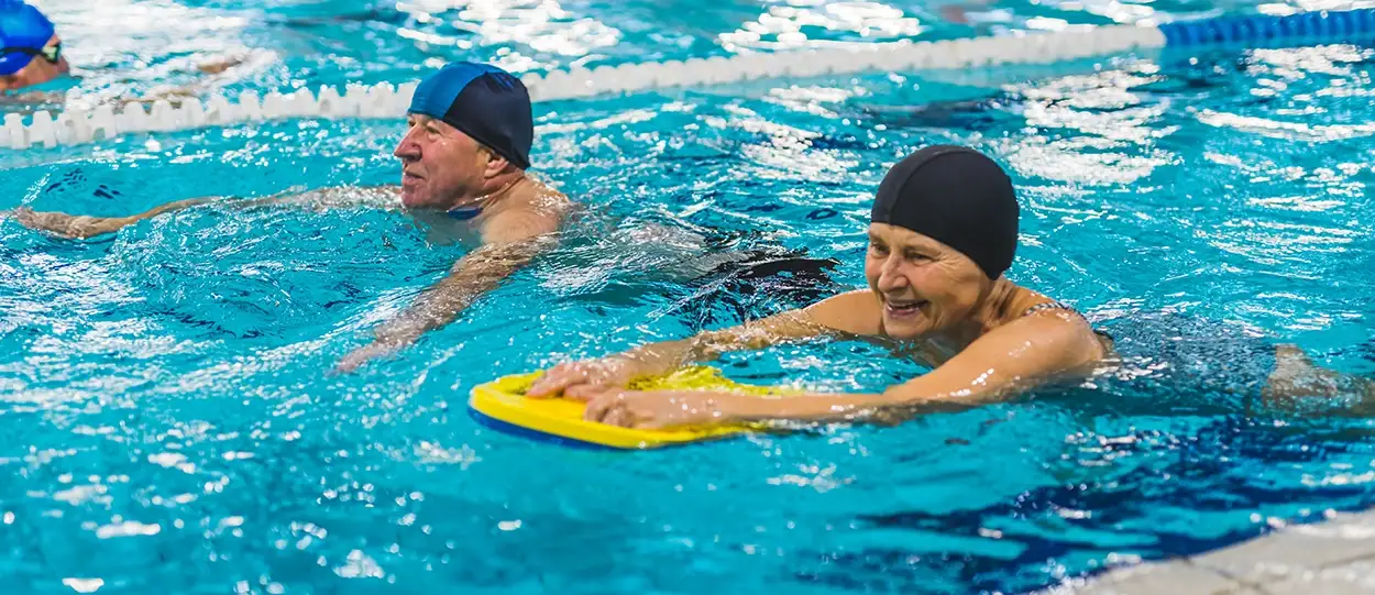 a group of people swimming in a pool