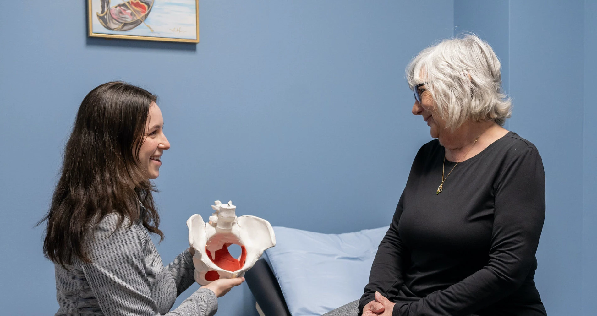 two women in a room with a blue wall