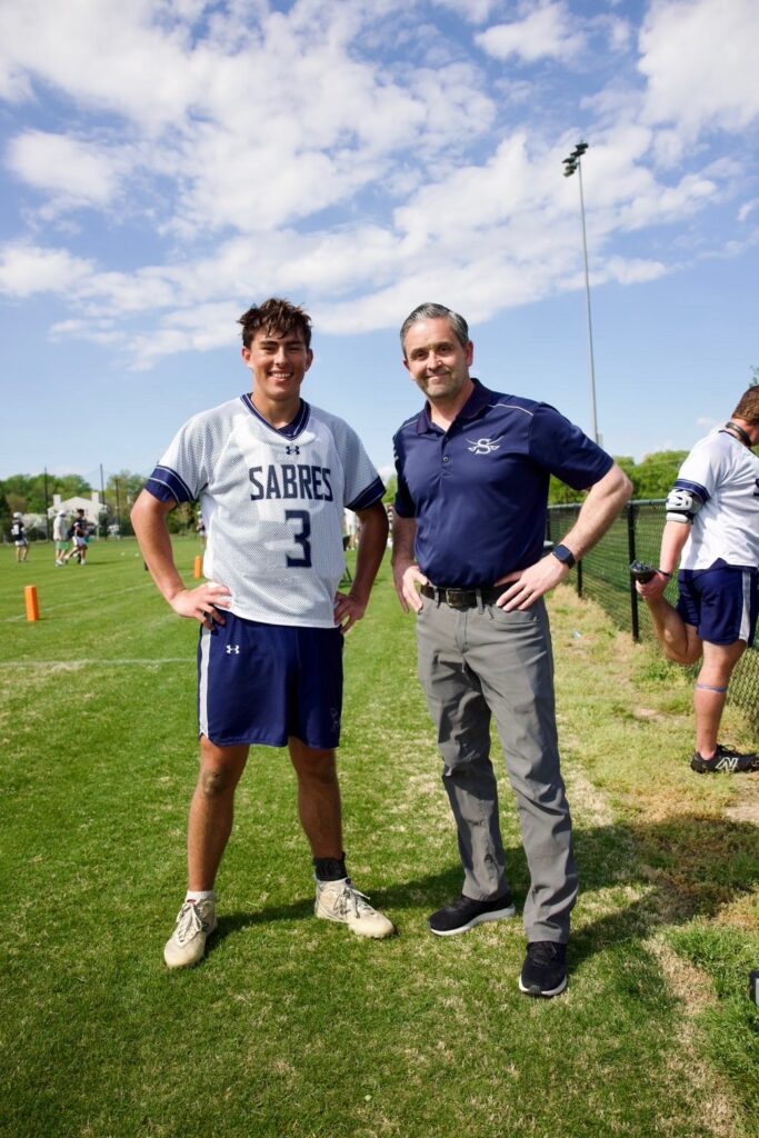 a couple of men standing next to each other on a field