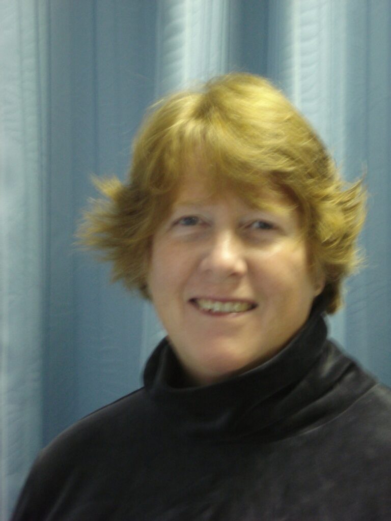 a woman with blonde hair is smiling for the camera