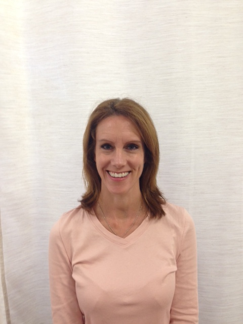 a woman standing in front of a white curtain