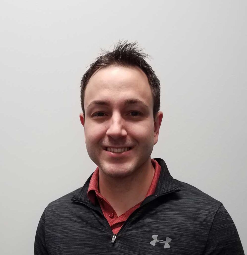 a man with a black and red shirt smiling