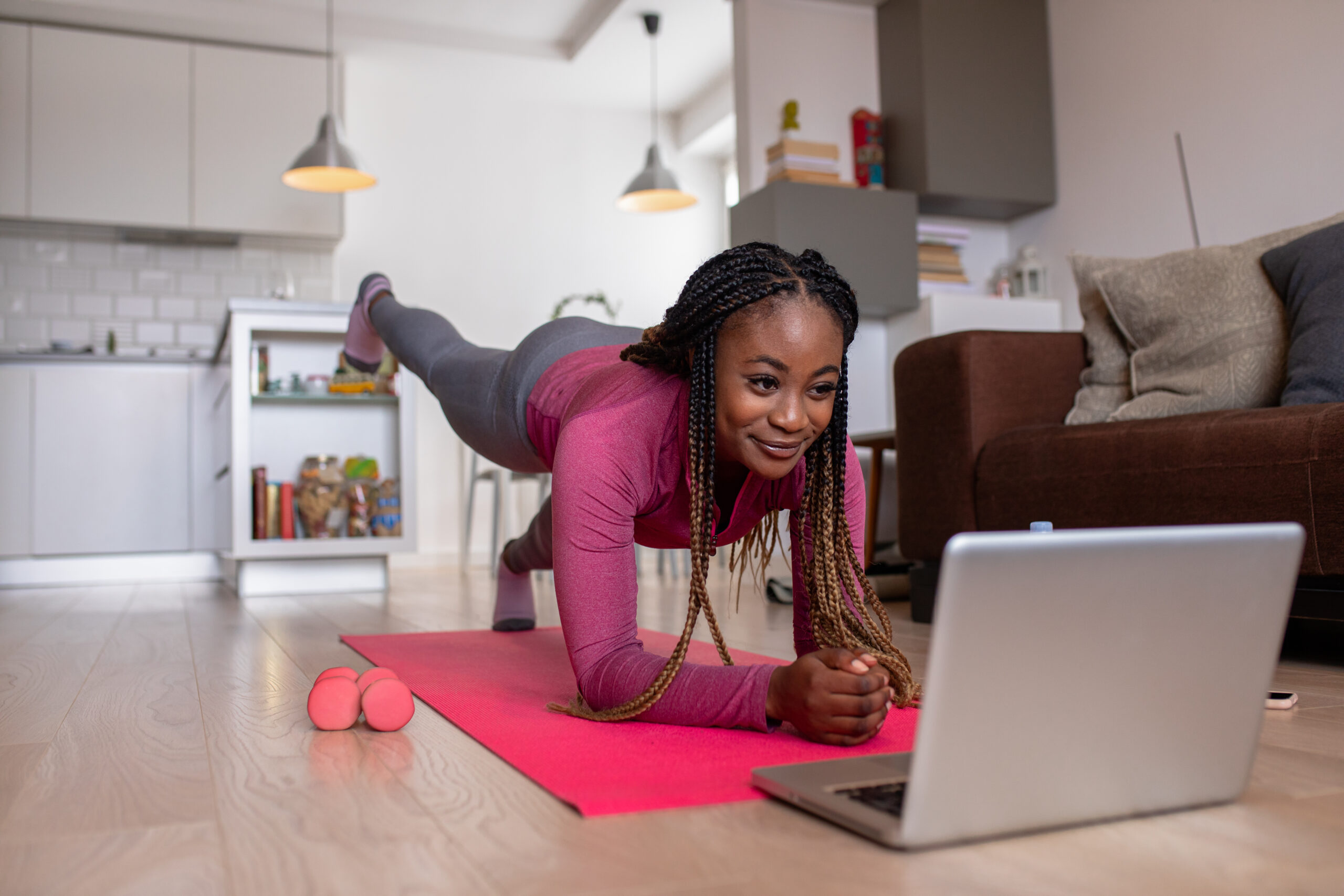 a woman is laying on the floor with her laptop