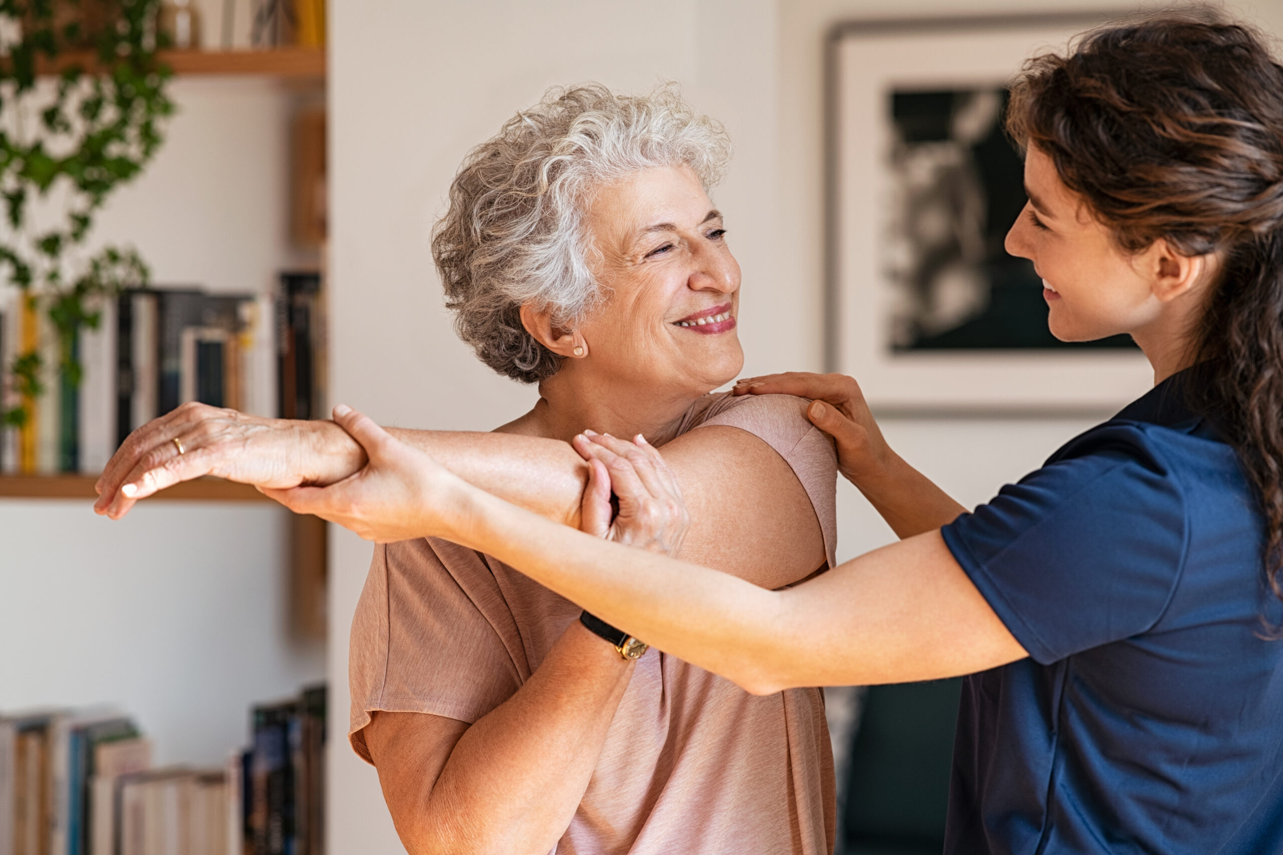 an older woman is helping another woman with her arm