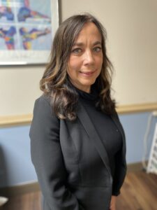 a woman standing in front of a painting