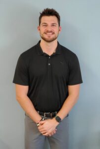 a man standing in front of a blue wall
