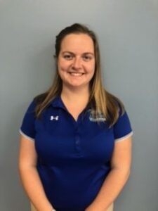 a woman in a blue shirt posing for a photo