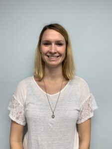 a woman with blonde hair wearing a white shirt