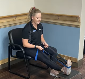 a woman sitting in a chair with her foot on the ground