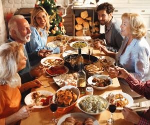 a group of people sitting around a table sharing a meal