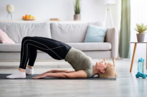 a woman is doing a yoga pose on the floor