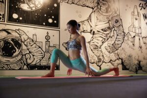 a woman is doing yoga in front of a wall