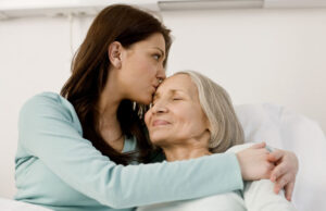a woman kissing another woman on the cheek