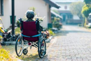 a woman in a wheelchair is walking down the street