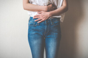 a person standing with their hands on their hips