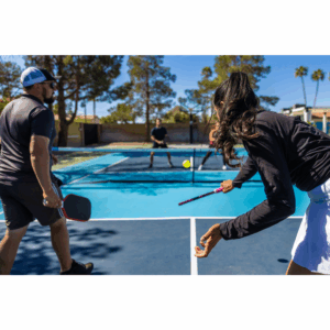 a man and woman playing pickleball on a court
